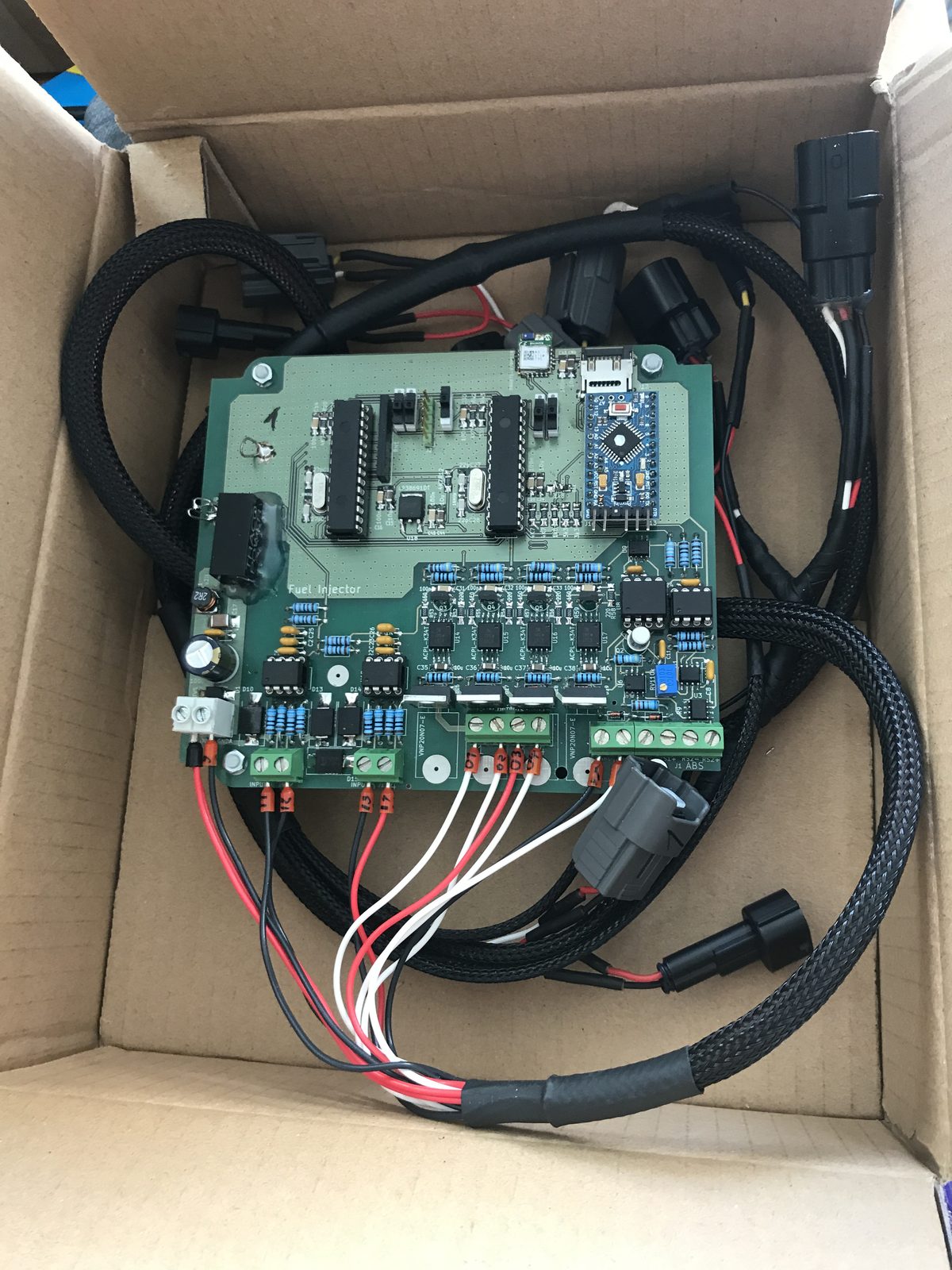 Finished prototype board with a sleeved wiring loom terminated in OEM-style motorcycle connectors
